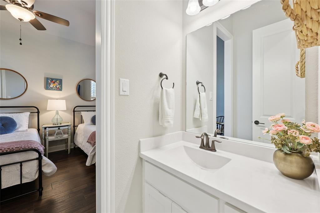 451 Morgan Lane Prosper, TX 75078 - Photo 32 of 38 a en suite bathroom with a granite countertop sink and a mirror