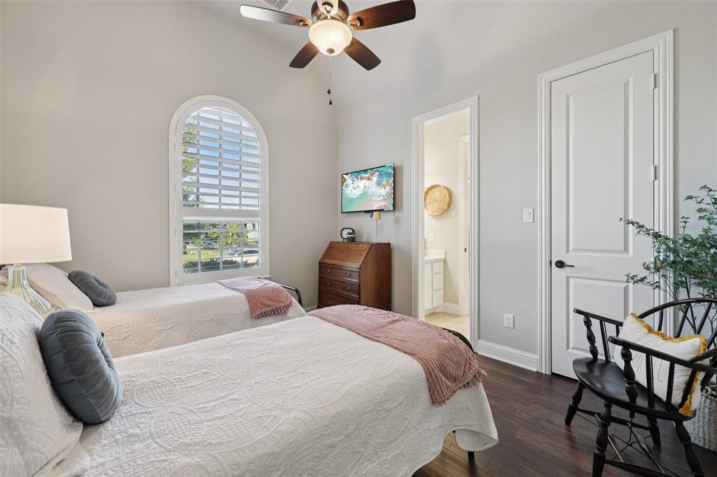 451 Morgan Lane Prosper, TX 75078 - Photo 33 of 38 a bedroom with a bed and a chandelier