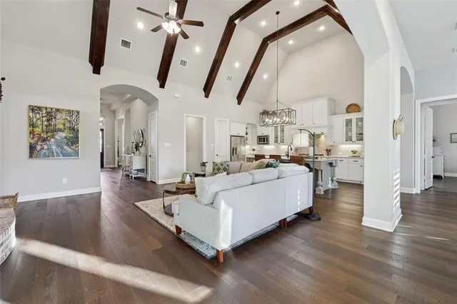 a living room with furniture and a chandelier