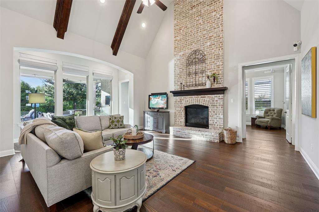 451 Morgan Lane Prosper, TX 75078 - Photo 7 of 38 a living room with furniture a fireplace and a floor to ceiling window