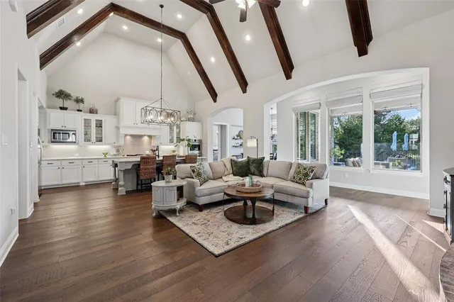 a living room with fireplace furniture and a large window