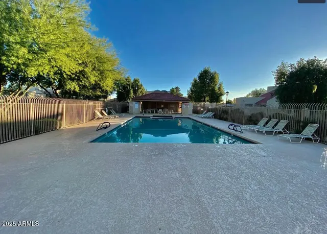 an outdoor space with pool and furniture