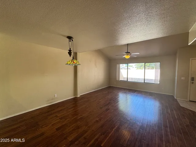 a view of a room with wooden floor and window