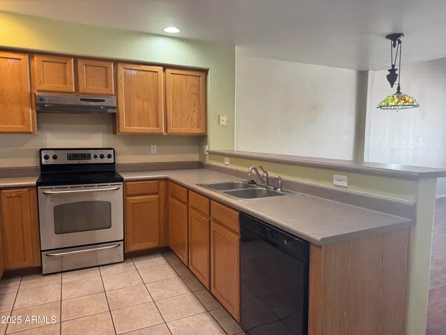 a kitchen with a sink stove and cabinets