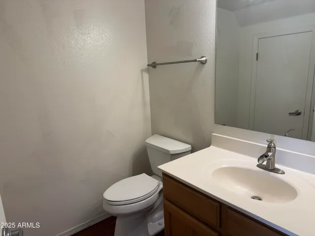 a bathroom with a sink toilet and a mirror