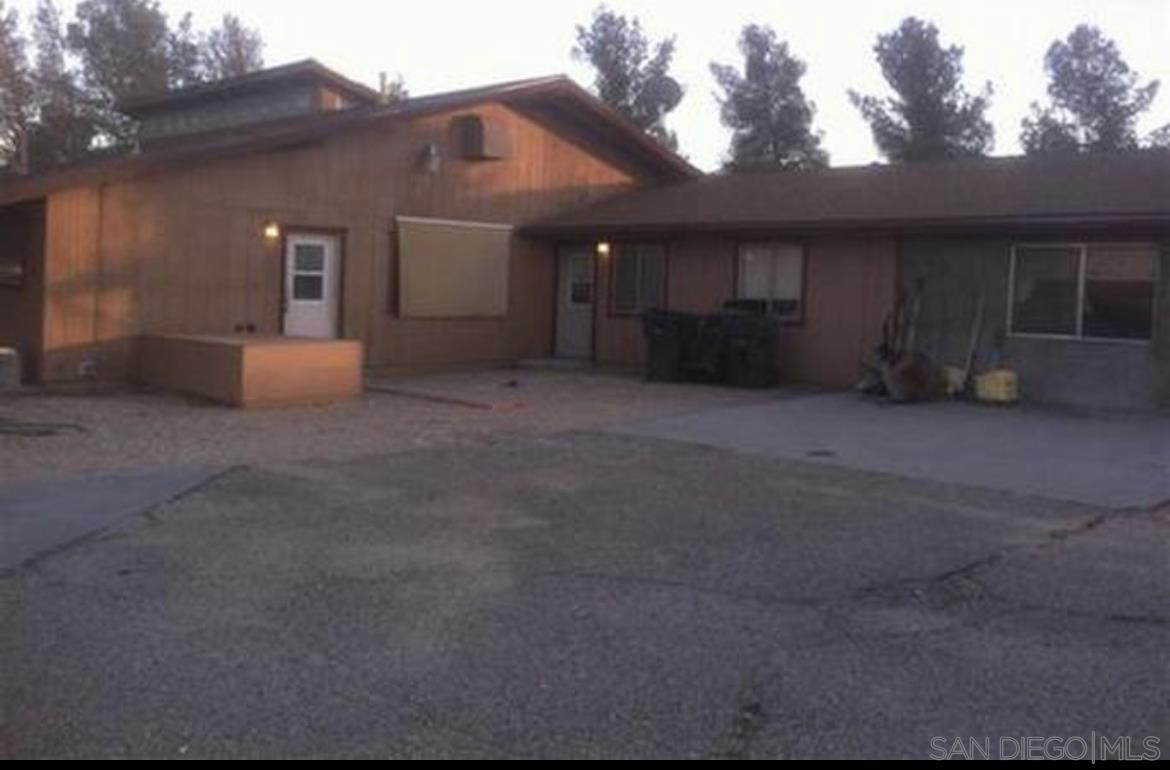 26012 Desert View Road Apple Valley, CA 92308 - Photo 1 of 7 a view of a house with a garage