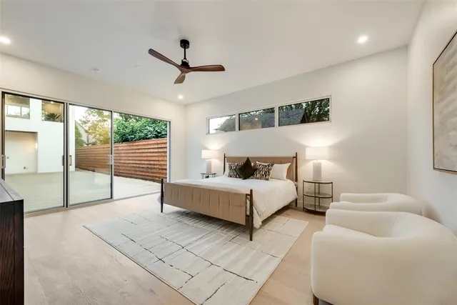 a spacious bedroom with a bed and large window
