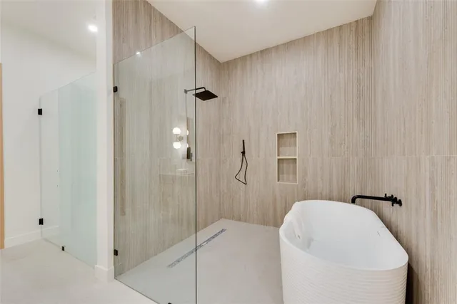 a bathroom with a bathtub and shower