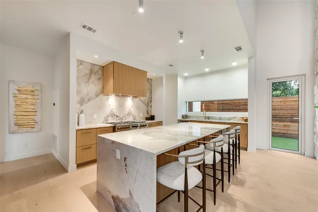 a kitchen with a table chairs and a refrigerator