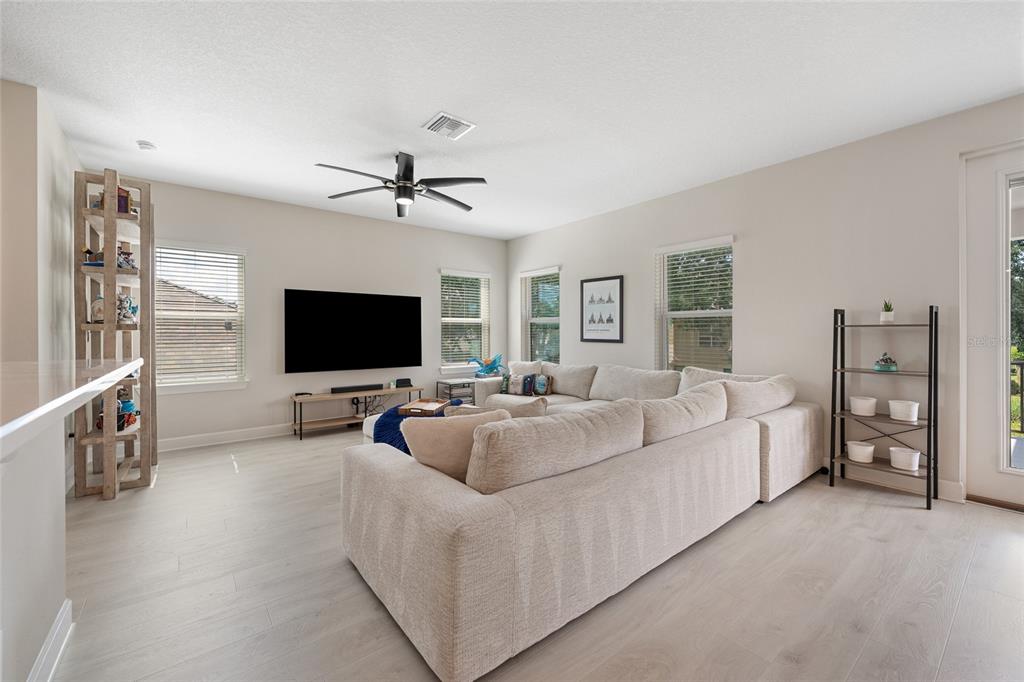 10175 Brocksport Circle Gotha, FL 34734 - Photo 33 of 54 a living room with furniture and a flat screen tv
