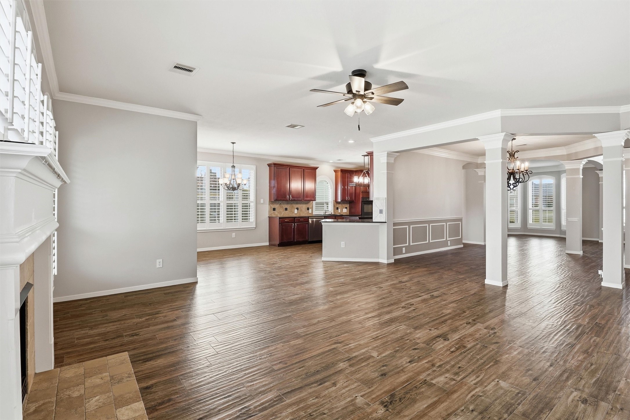 3602 River Bend Drive Rosenberg, TX 77471 - Photo 27 of 49 a view of a kitchen with a refrigerator a ceiling fan and a fireplace