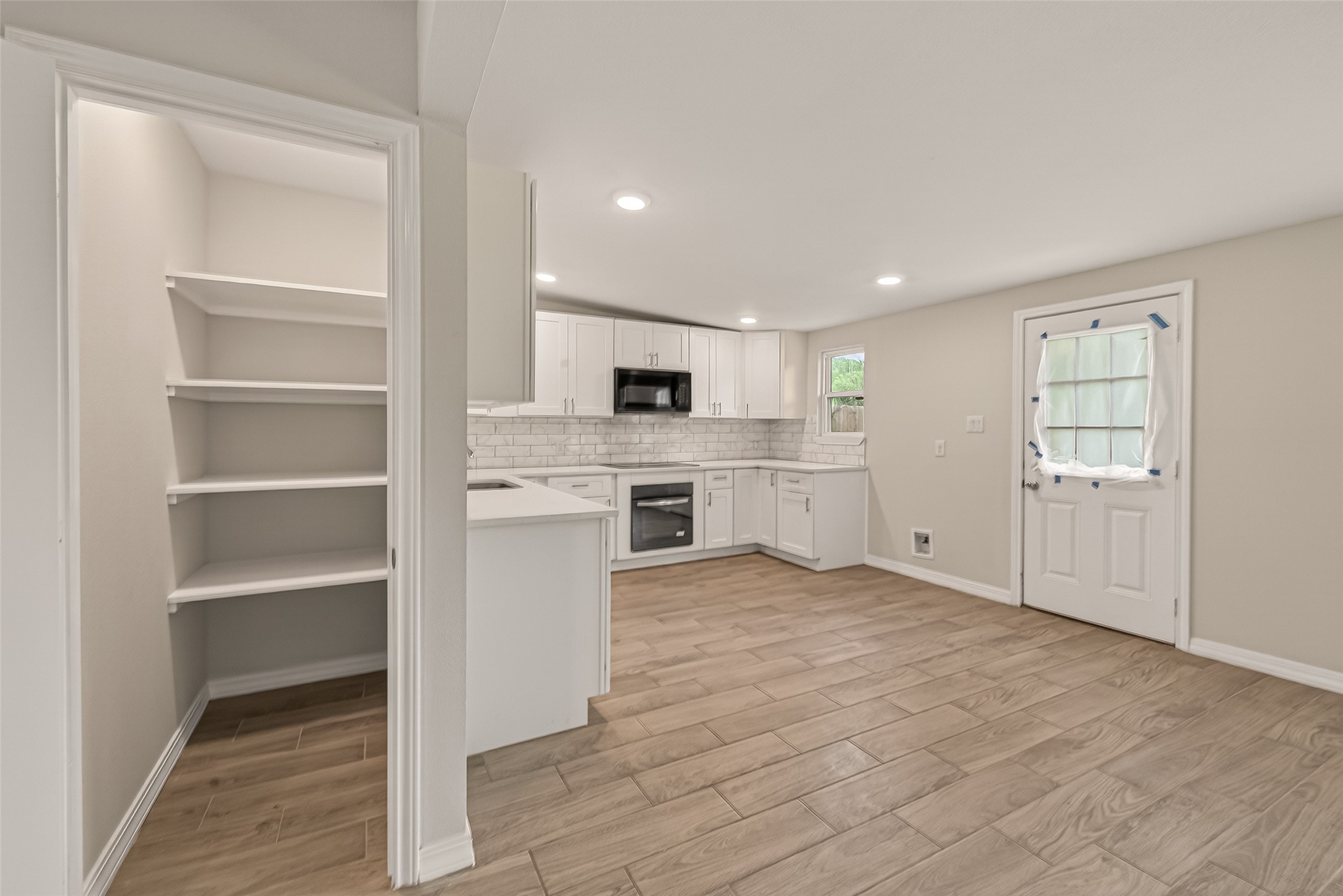 3710 Daphne Street Houston, TX 77021 - Photo 15 of 39 a view of a kitchen with white cabinets and a refrigerator