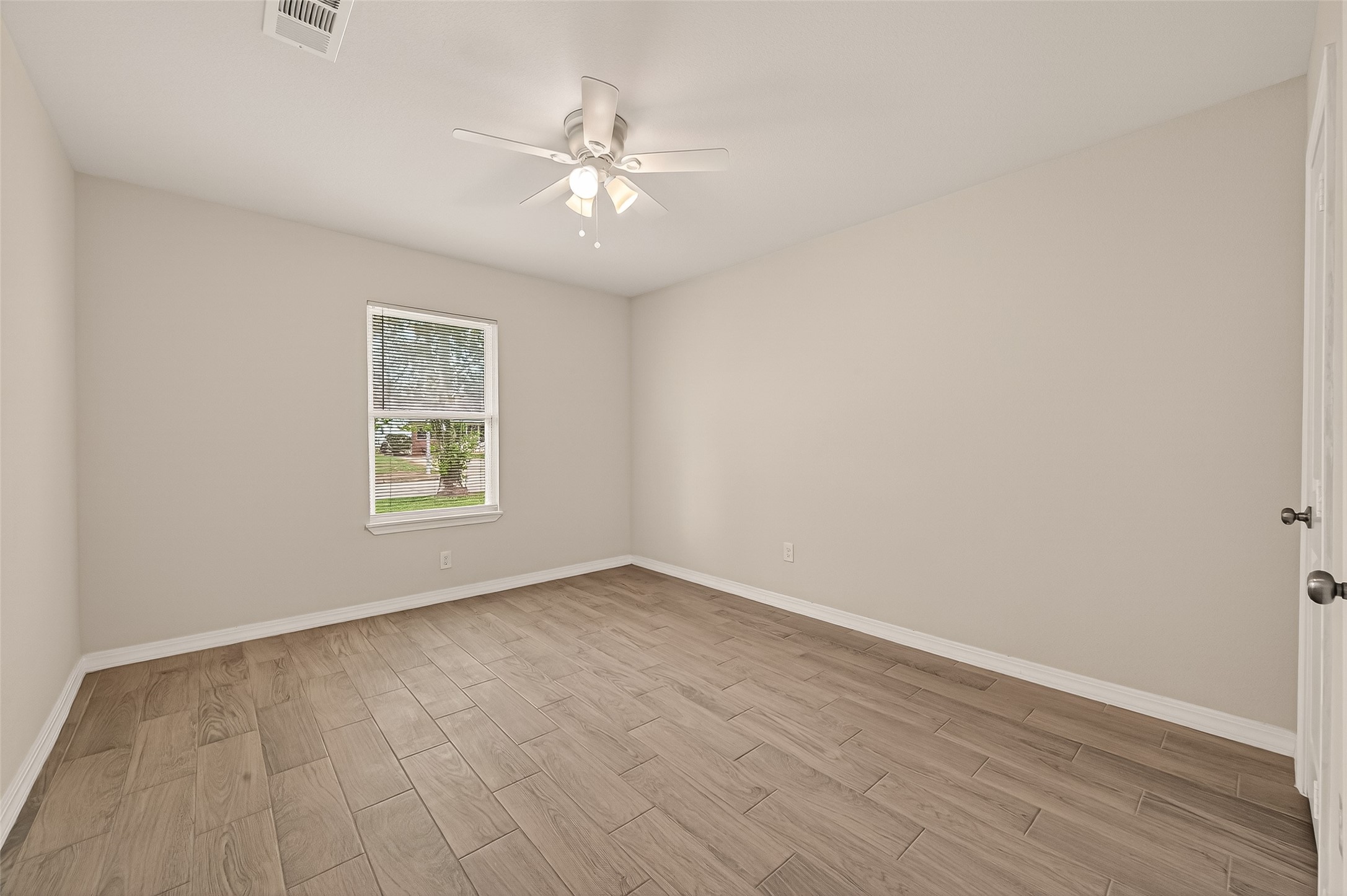 3710 Daphne Street Houston, TX 77021 - Photo 16 of 39 an empty room with wooden floor and windows