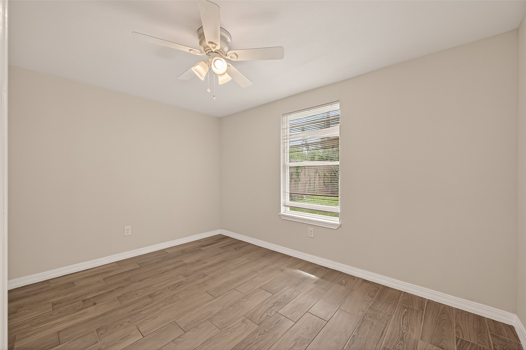 3710 Daphne Street Houston, TX 77021 - Photo 21 of 39 an empty room with wooden floor and windows