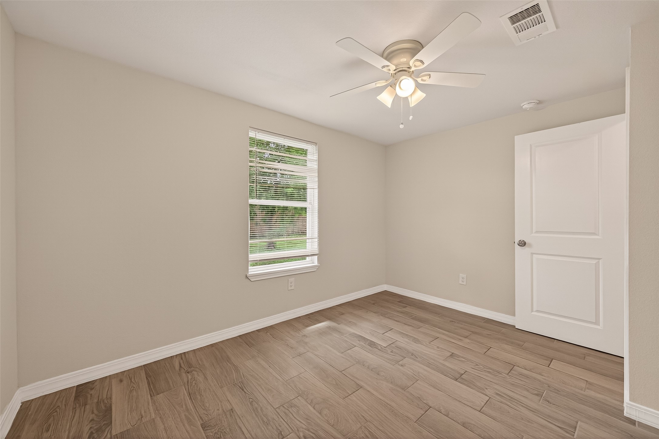 3710 Daphne Street Houston, TX 77021 - Photo 23 of 39 wooden floor in an empty room with a window