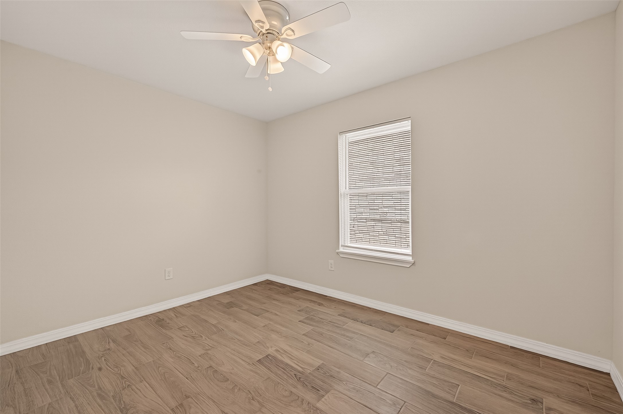 3710 Daphne Street Houston, TX 77021 - Photo 24 of 39 an empty room with a window and wooden floor