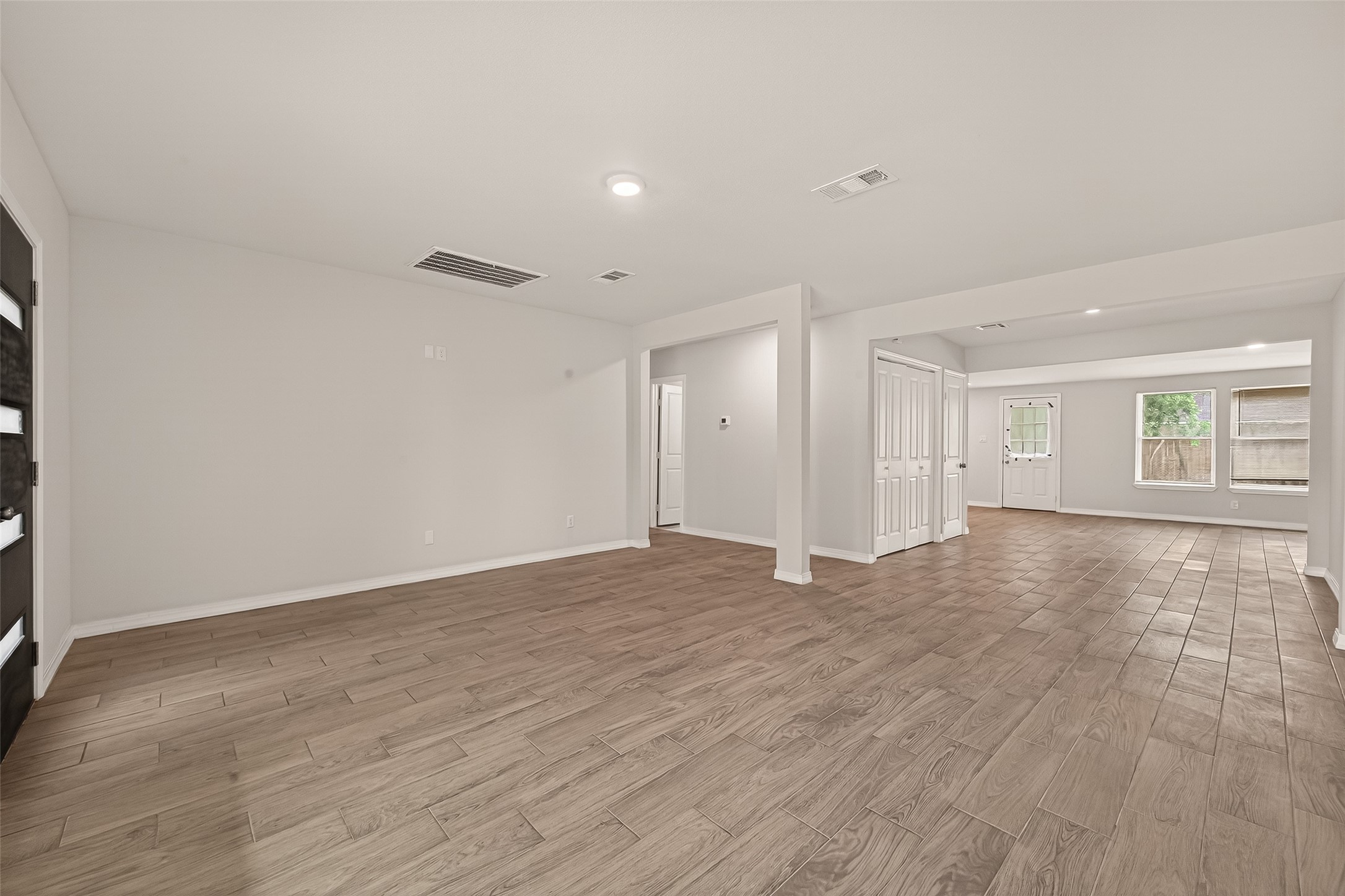 3710 Daphne Street Houston, TX 77021 - Photo 6 of 39 a view of an empty room with window and wooden floor