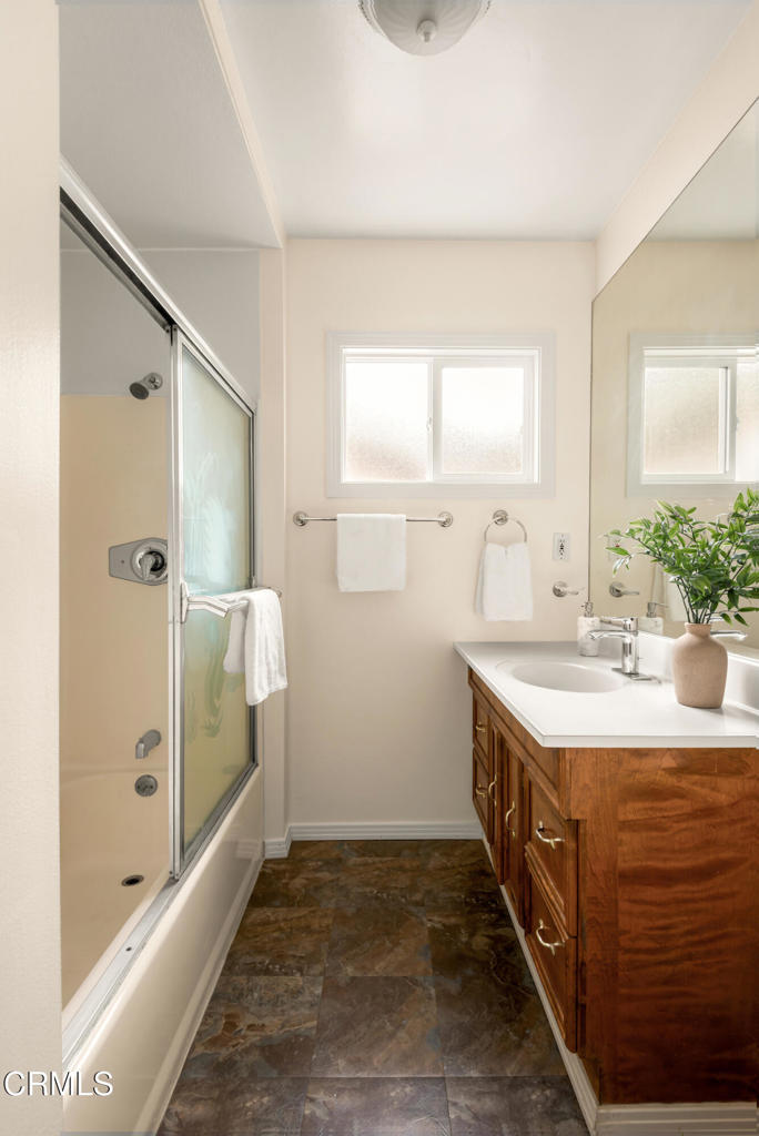 1587 North Harding Avenue Pasadena, CA 91104 - Photo 28 of 37 a bathroom with a granite countertop sink a mirror and a bathtub