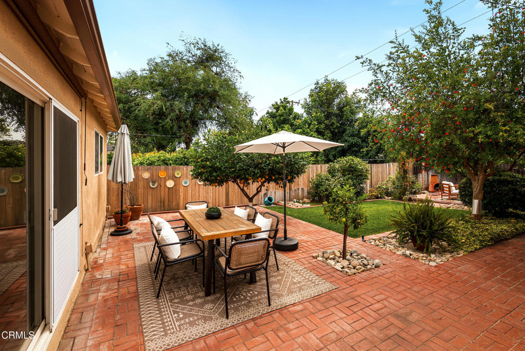 1587 North Harding Avenue Pasadena, CA 91104 - Photo 30 of 37 a view of a patio with a table and chairs under an umbrella with a small yard