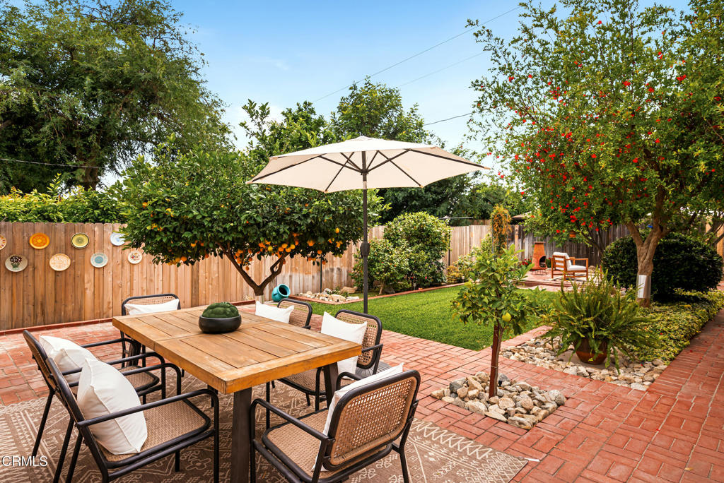 1587 North Harding Avenue Pasadena, CA 91104 - Photo 31 of 37 a patio with a table and chairs under an umbrella