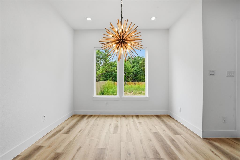 1111 Riverwood Road Dallas, TX 75217 - Photo 27 of 40 Room featuring a contemporary sputnik chandelier, wood-finish flooring, and recessed ceiling lighting