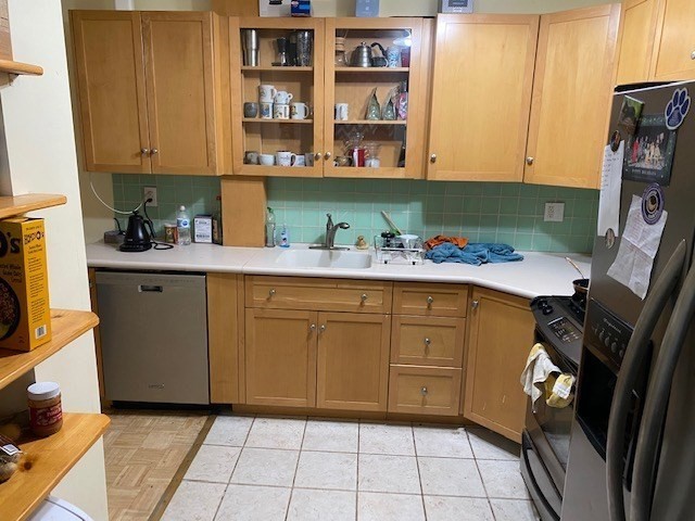 231 High Street, Unit 2 Brookline, MA 02445 - Photo 2 of 12 a utility room with cabinets washer and dryer