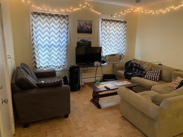 231 High Street, Unit 2 Brookline, MA 02445 - Photo 3 of 12 a living room with furniture and a flat screen tv