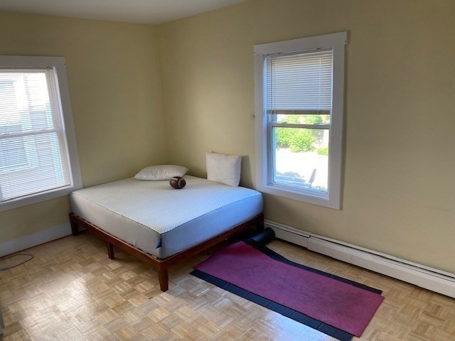 231 High Street, Unit 2 Brookline, MA 02445 - Photo 5 of 12 a bedroom with a bed and window