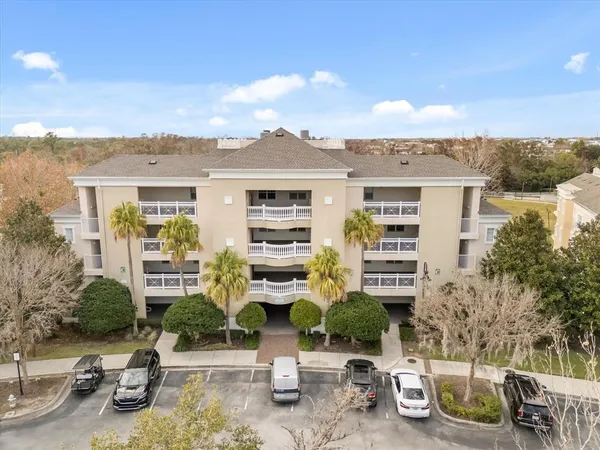 a front view of a building with glass windows and potted plants