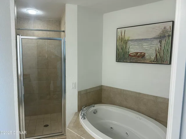 a bathroom with a tub and shower