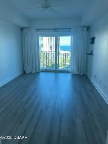 a view of a room with wooden floor and windows