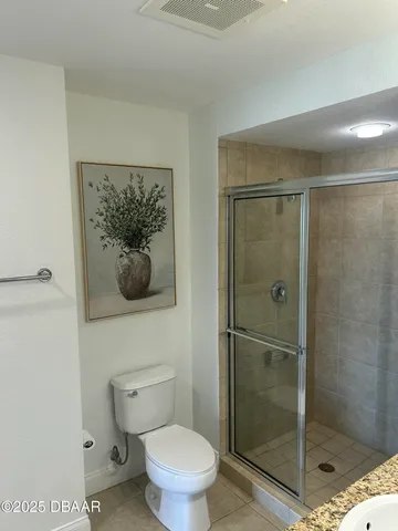 a bathroom with a shower and toilet