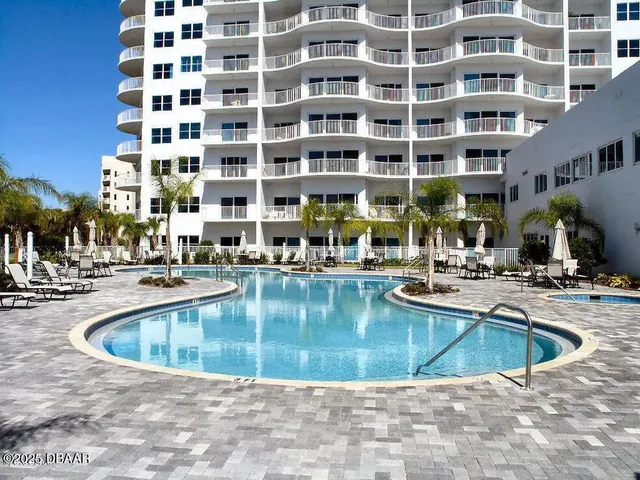 a view of a swimming pool with outdoor seating