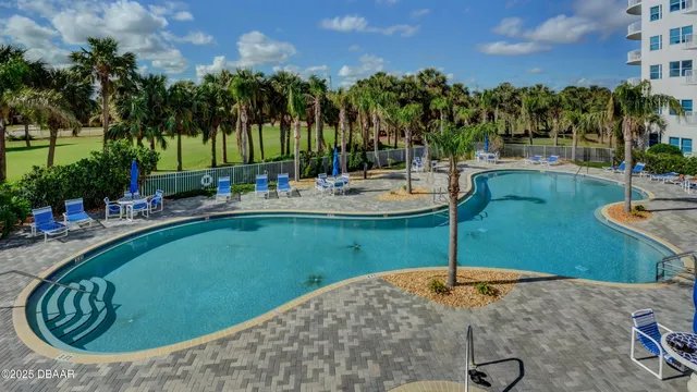 a view of a swimming pool with a patio
