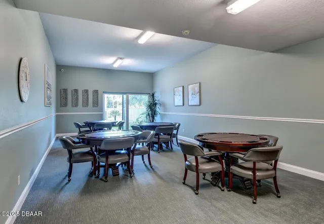 a view of a dining room with furniture and a window