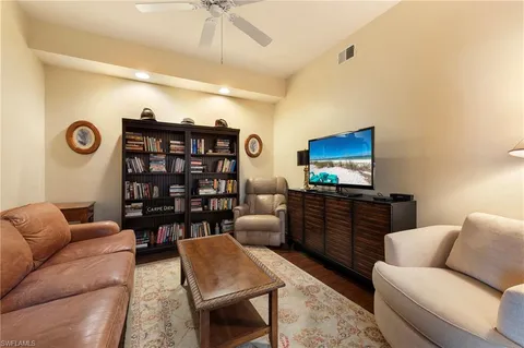 a bedroom with furniture and a flat screen tv