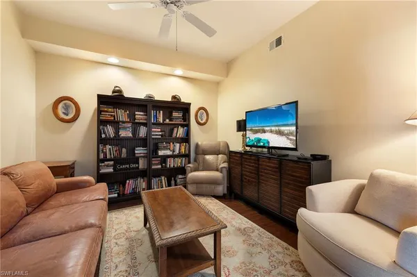a bedroom with furniture and a flat screen tv