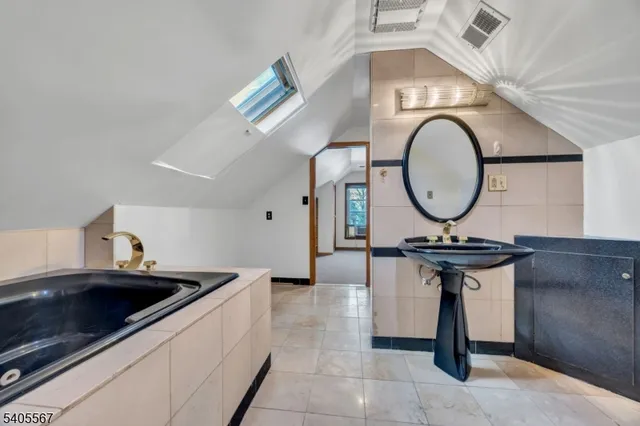 a living room with furniture a mirror and a clock