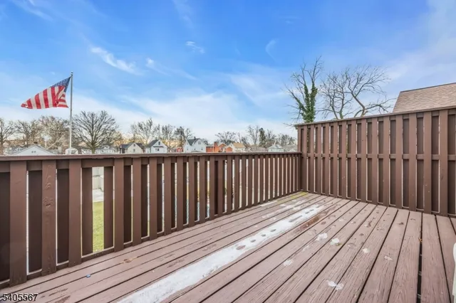a balcony with wooden floor and fence