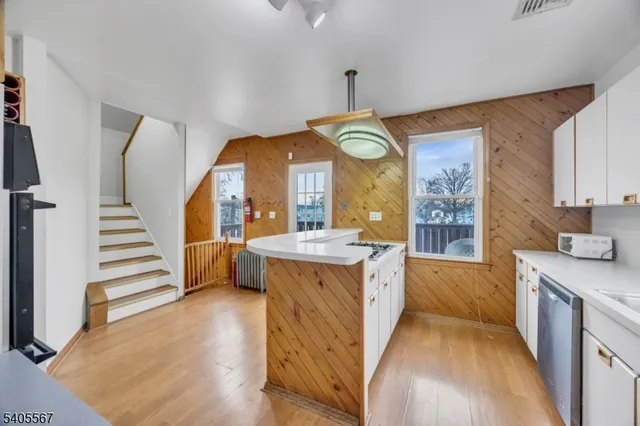 a view of a kitchen with cabinets and wooden floor