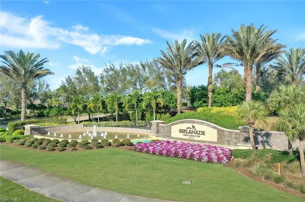 a view of a bench in front of house with yard