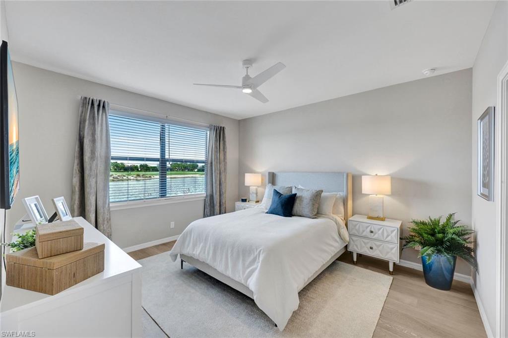 9373 Pocida Court, Unit 104 Naples, FL 34119 - Photo 11 of 24 a bedroom with a bed and a couch