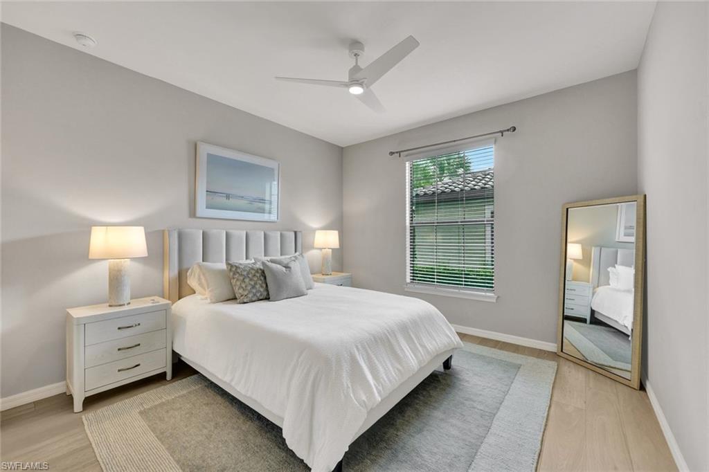 9373 Pocida Court, Unit 104 Naples, FL 34119 - Photo 14 of 24 a bedroom with double bed and a window