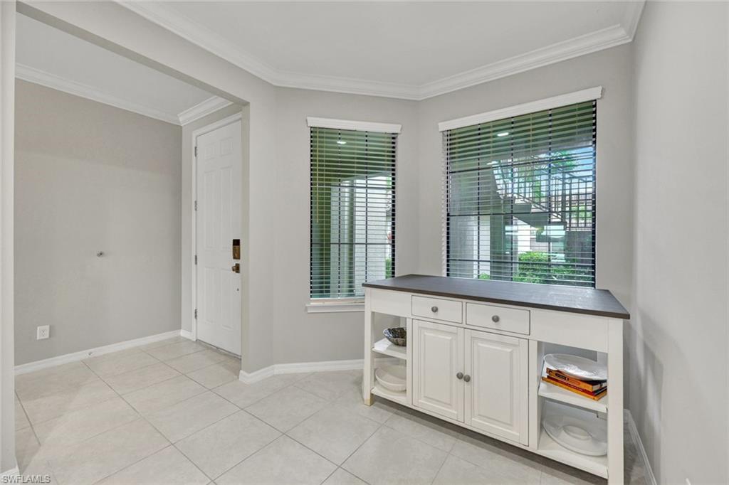 9373 Pocida Court, Unit 104 Naples, FL 34119 - Photo 3 of 24 a view of an empty room with window cabinet and bathroom