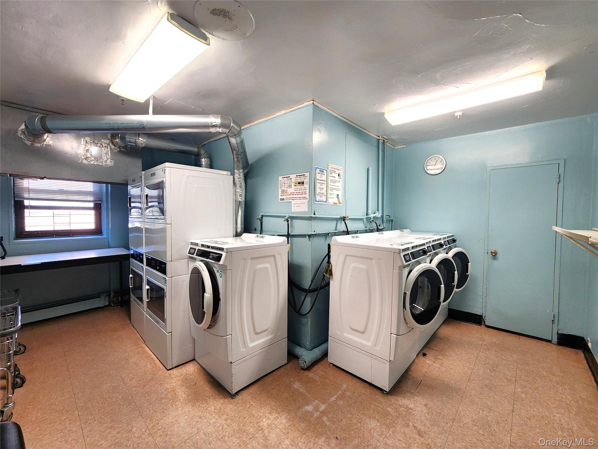 25 Park Place, Unit 3R Great Neck, NY 11021 - Photo 16 of 18 a utility room with dryer and washer