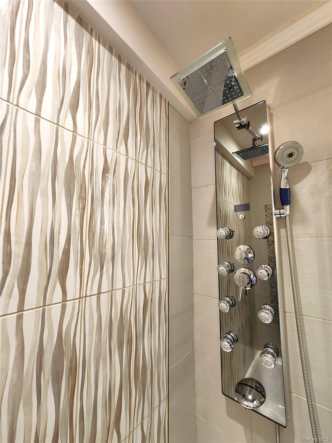 25 Park Place, Unit 3R Great Neck, NY 11021 - Photo 5 of 18 a bathroom with a window and shower curtain