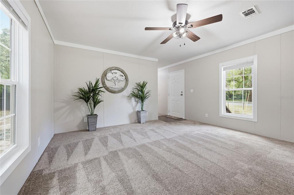 215 Southwest Alpine Place High Springs, FL 32643 - Photo 11 of 41 a view of an empty room with a window and a chandelier fan