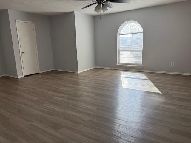 6000 Westridge Lane, Unit 802 Fort Worth, TX 76116 - Photo 4 of 12 an empty room with wooden floor chandelier fan and windows