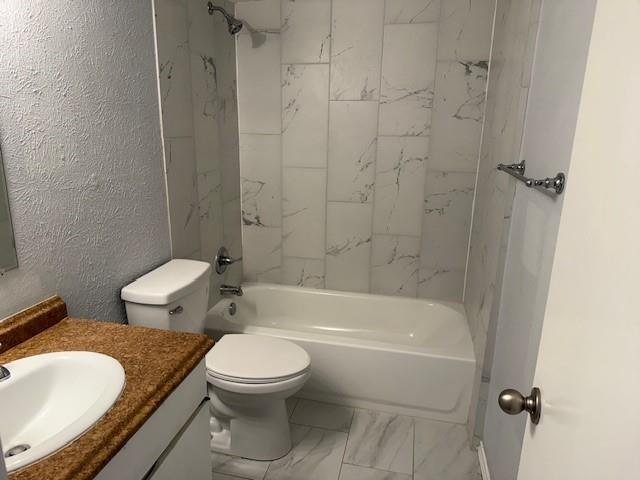 6000 Westridge Lane, Unit 802 Fort Worth, TX 76116 - Photo 8 of 12 a white toilet and tub sitting next to a bathroom sink