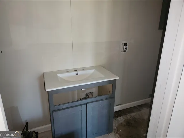 a utility room with a sink washer and dryer